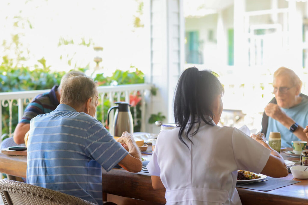 Elderly residents dining together in a nursing home or care facility in Thailand