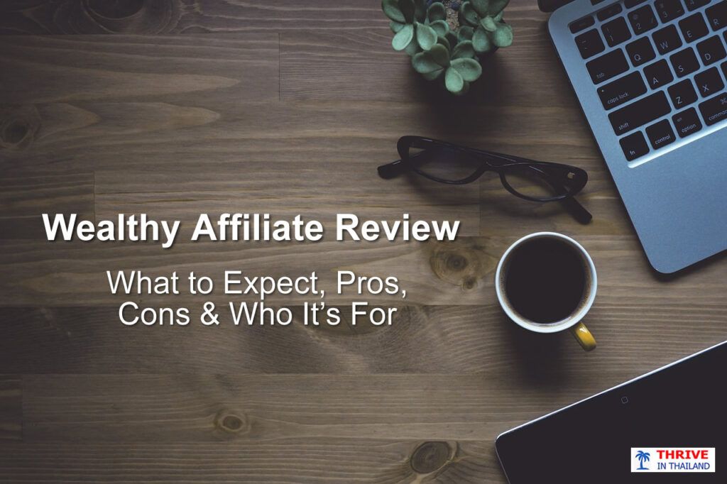 Wealthy Affiliate review header showing a calm wooden desk workspace with laptop, coffee, and glasses representing an honest, analytical evaluation of the platform