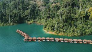 Floating raft houses on turquoise Cheow Lan Lake in Khao Sok National Park, Thailand