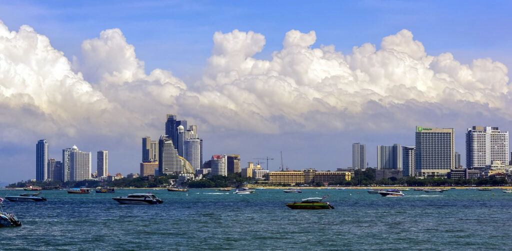 View of Pattaya city skyline with speedboats and buildings seen from the sea