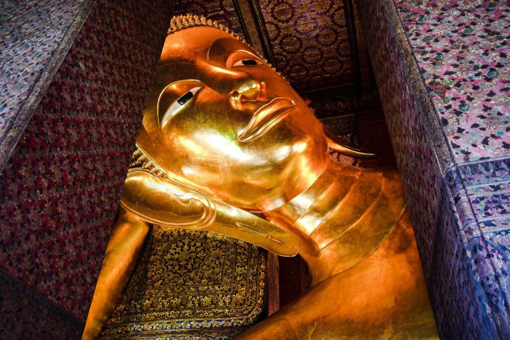 Close-up of the golden Reclining Buddha inside Wat Pho in Bangkok.