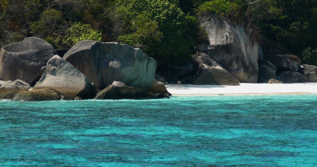 Granite rock formations and white sand beach with clear turquoise water at Similan Islands National Marine Park, Thailand