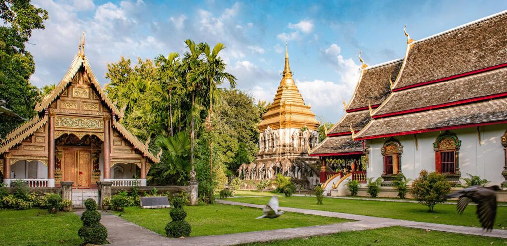 Wat Chiang Man temple with golden chedi and elephant sculptures in Chiang Mai, Thailand
