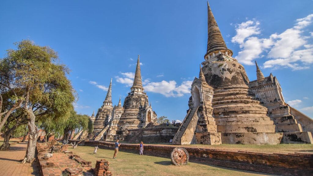 Iconic stupas of Wat Phra Si Sanphet under a bright blue sky in Ayutthaya Historical Park