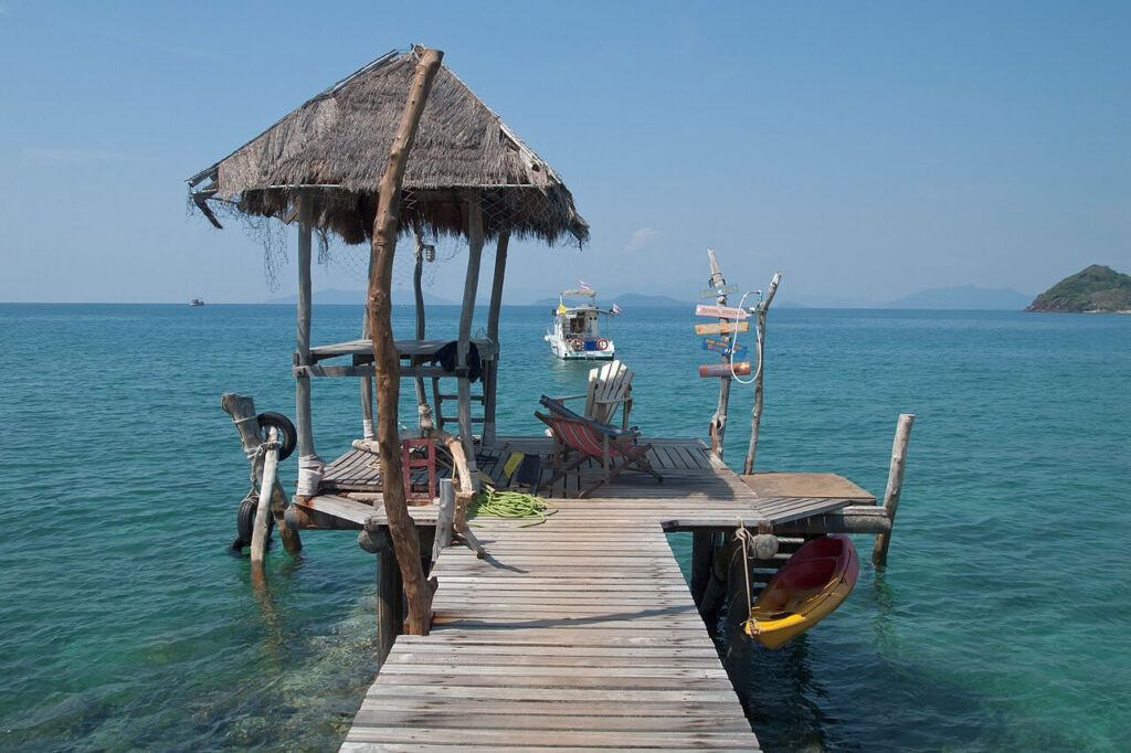 Wooden pier with rustic hut and chairs overlooking the sea on Koh Mak, Thailand