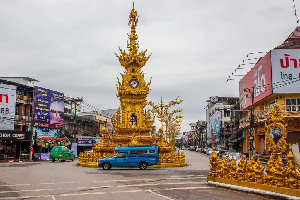 Golden Clock Tower in Chiang Rai, Thailand, a landmark roundabout in the city center designed by artist Chalermchai Kositpipat.