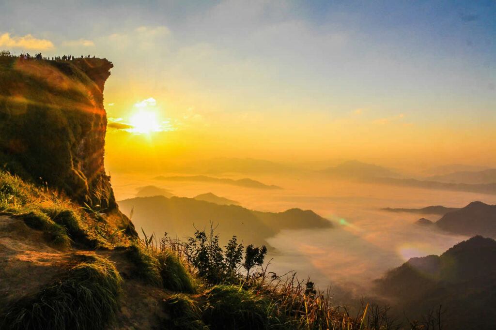 Sunrise over the misty mountains at Phu Chi Fa, a famous cliff viewpoint in Chiang Rai, Thailand.