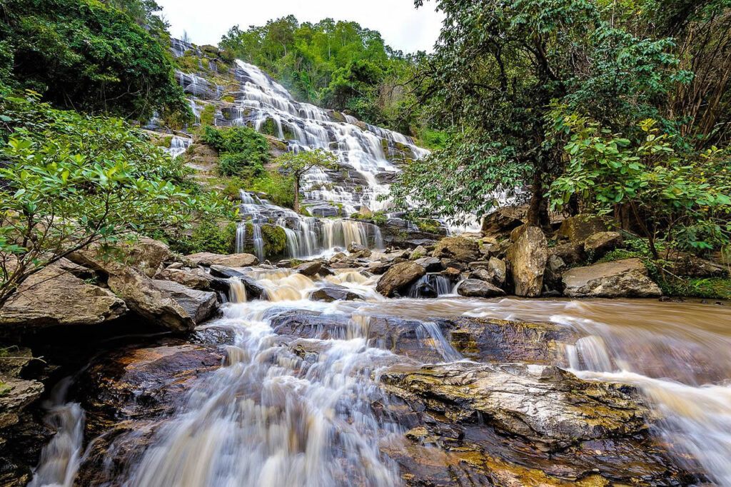 Mae Ya Waterfall cascading over rock tiers surrounded by lush forest in Doi Inthanon National Park, Chiang Mai