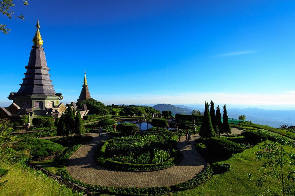 Twin Royal Pagodas and landscaped gardens at Doi Inthanon National Park, Chiang Mai, Thailand, with mountain views in the background.