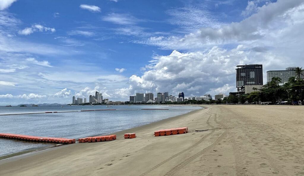 View of Pattaya Beach with high-rise hotels and city skyline in the background.