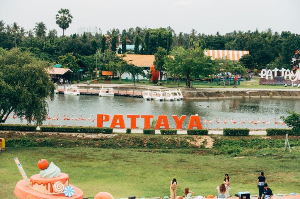 Large Pattaya sign overlooking the lake and swan paddle boats at Pattaya Sheep Farm.