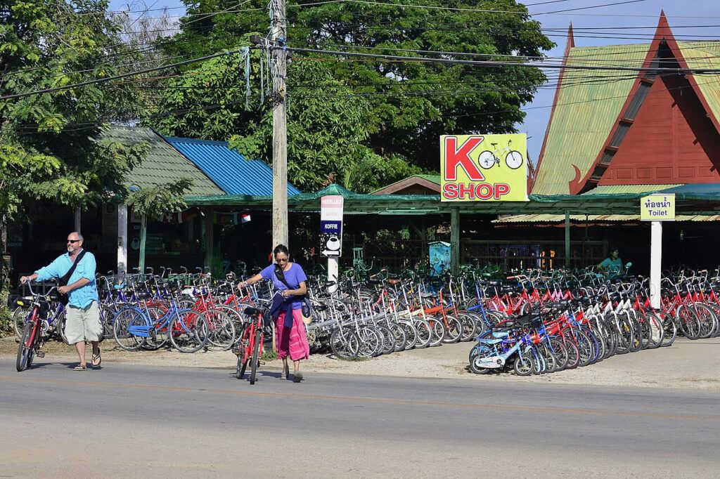 Tourists renting bicycles at a shop near Sukhothai Historical Park, Thailand, a popular way to explore the ruins