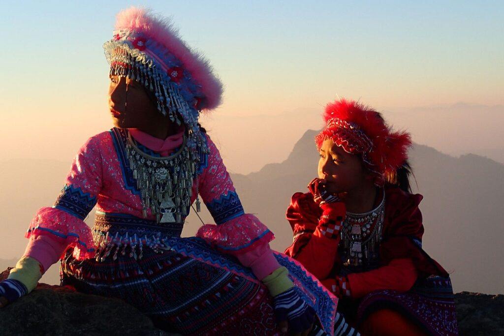 Hmong Akha girls in traditional dress at Phu Chi Fa during sunrise