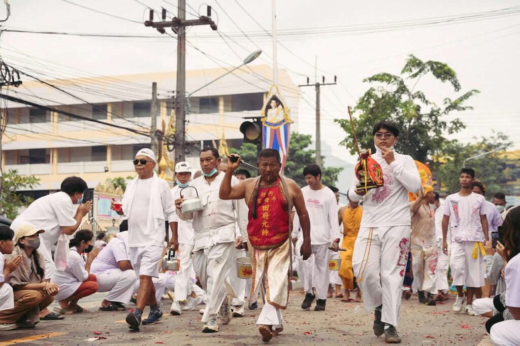Devotees walking in a street procession during the Phuket Vegetarian Festival