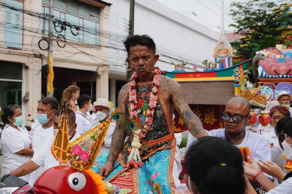 Spirit medium carried during a ceremonial procession at the Phuket Vegetarian Festival
