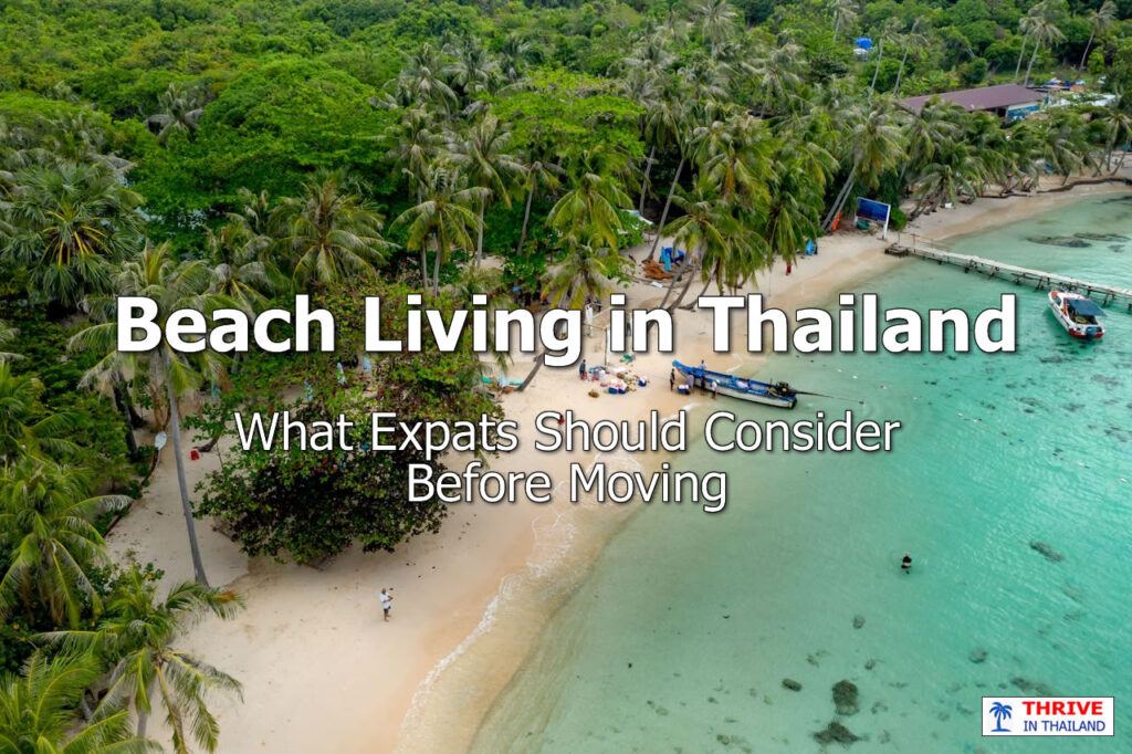 Aerial view of a tropical coastal village in Thailand with palm trees, longtail boats, and turquoise water