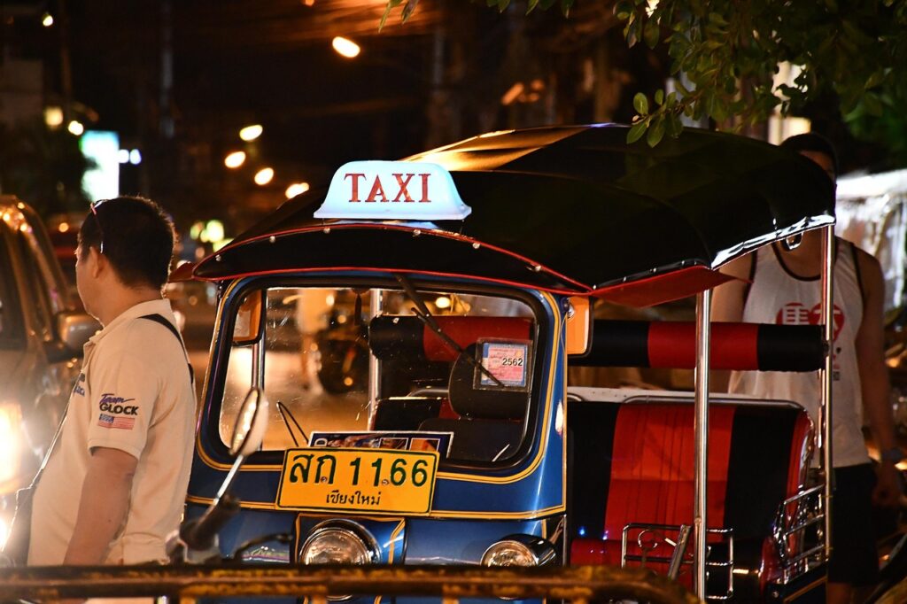 Tuk-tuk taxi waiting for passengers on a street in Chiang Mai, Thailand