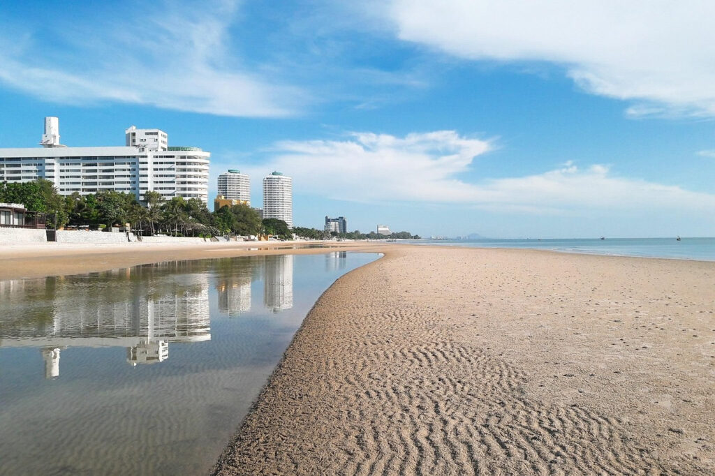 Hua Hin beach with coastal buildings and calm shoreline reflecting everyday expat life in Thailand