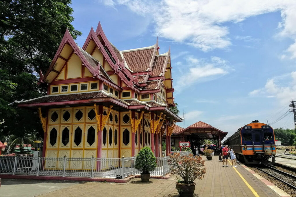 Hua Hin Railway Station with traditional pavilion and train at the platform