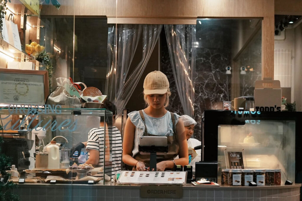 Young worker at a café in Thailand showing everyday urban work life after migration