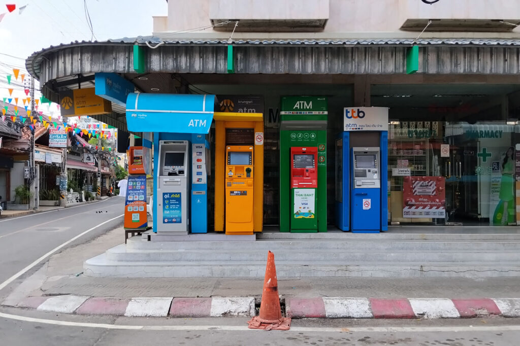 Multiple Thai bank ATM machines along a street in Hua Hin, highlighting convenient everyday banking access for residents and expats.