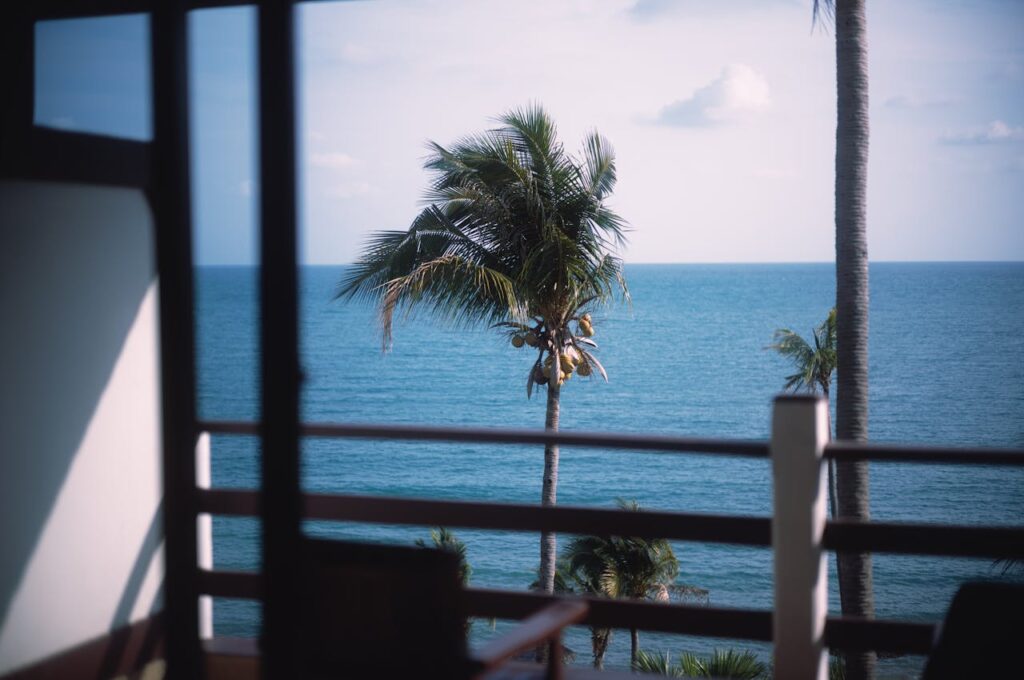 View from a coastal condo balcony overlooking the sea, representing short-term rental living in Thailand.