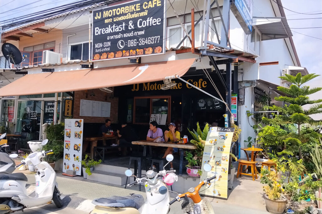 Cafe with outdoor seating and parked scooters in Hua Hin, Thailand