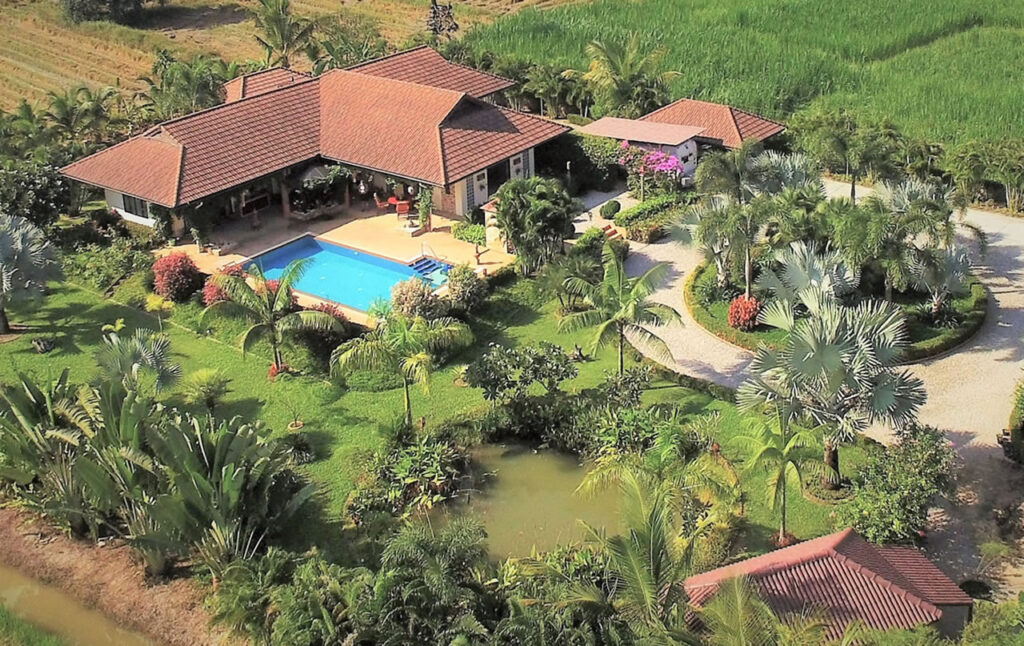 Large pool villa with private swimming pool, landscaped gardens, and spacious grounds in Thailand