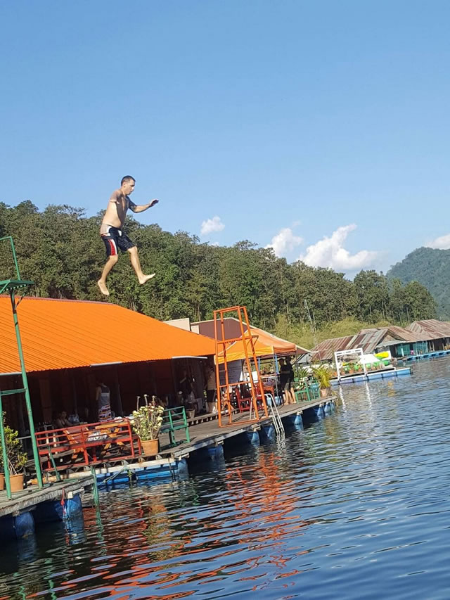 Jumping into the water from a floating resort at Mae Ngat Reservoir near Chiang Mai