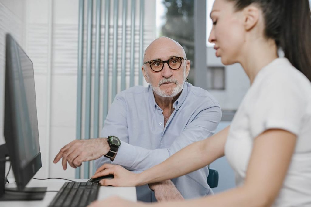 Older man discussing medical information with a healthcare professional