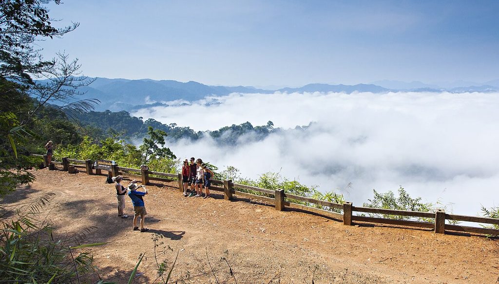Visitors overlooking morning mist at Phanoen Thung viewpoint in Kaeng Krachan National Park