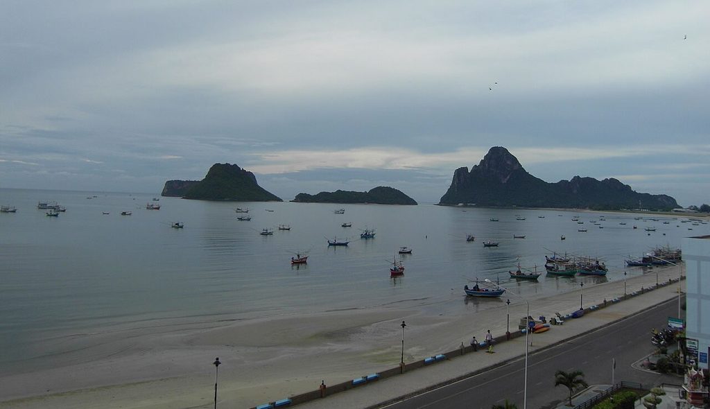 Fishing boats in Prachuap Khiri Khan Bay beneath limestone hills