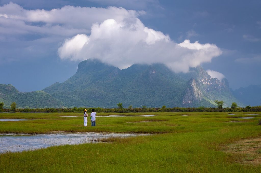Wetlands beneath cloud-covered limestone mountains in Sam Roi Yot National Park